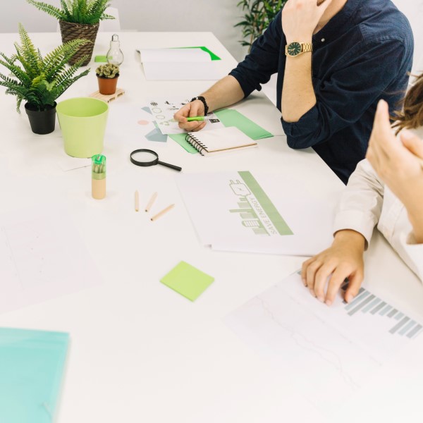 businesspeople-with-graph-energy-saving-concept-paper-desk